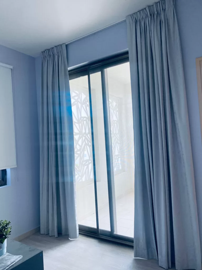 Pinch pleated blackout curtains installed in a private apartment in Dubai.