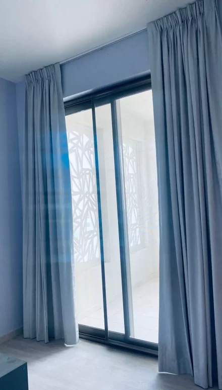 Pinch pleated blackout curtains installed in a private apartment in Dubai.